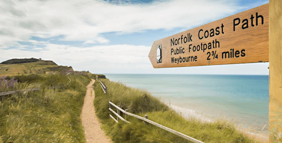 Norfolk Coast Path signpost above the beach on the North Norfolk coast