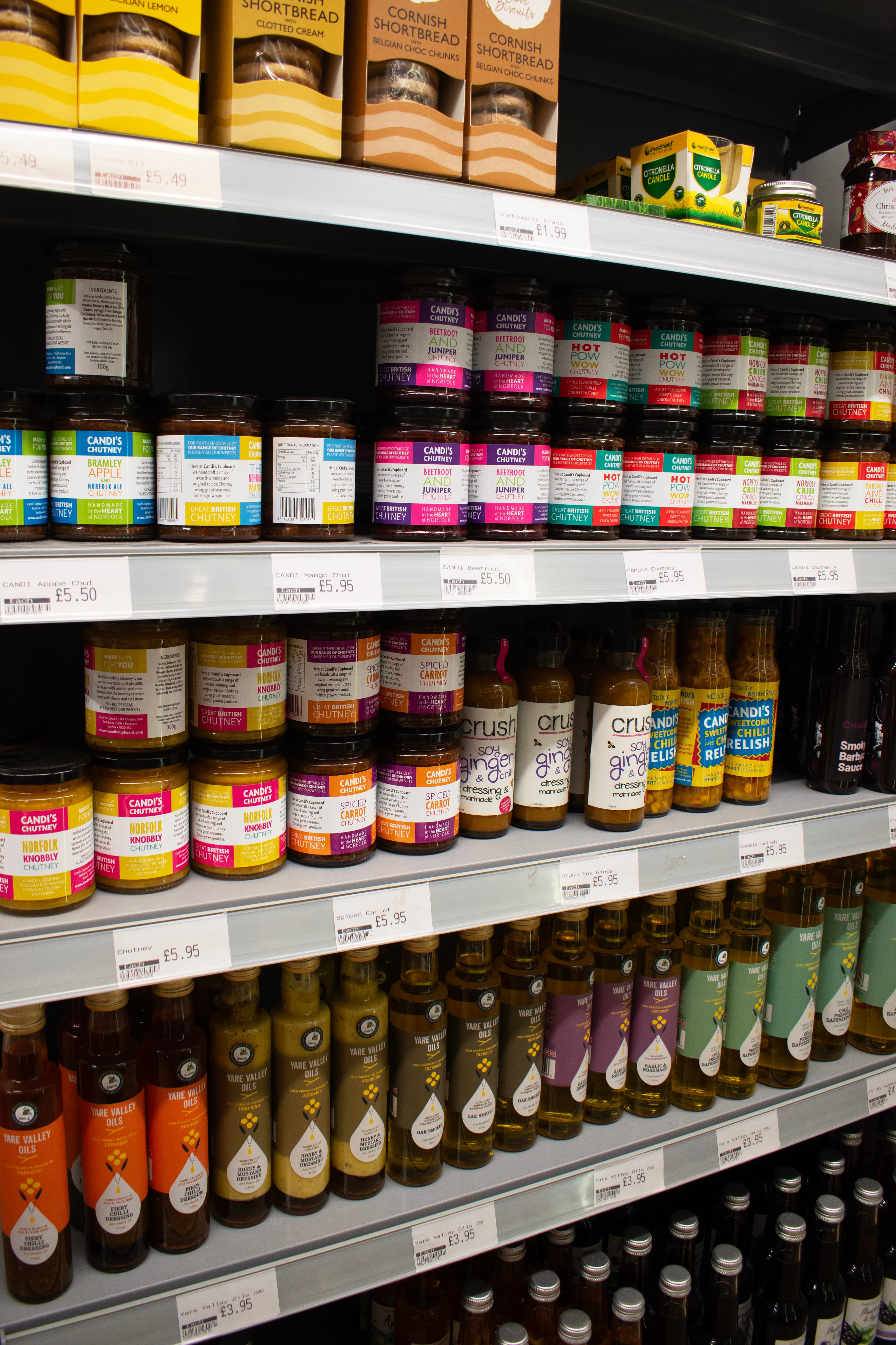 Grocery aisle stocked with store-cupboard essentials at Brancaster Stores